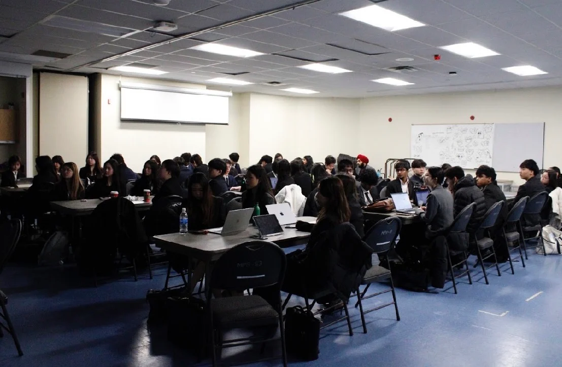The competition room full of teams at work